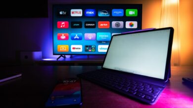 A modern home setup with a smart TV and tablet displaying various streaming apps, highlighting the digital lifestyle.