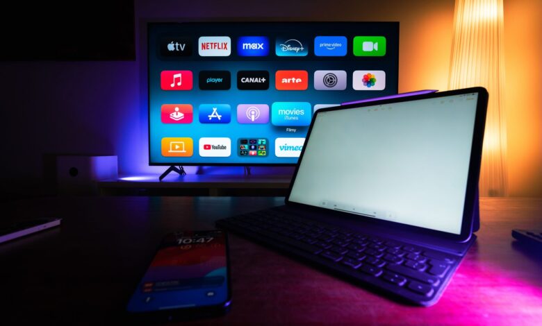 A modern home setup with a smart TV and tablet displaying various streaming apps, highlighting the digital lifestyle.