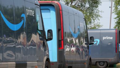 Amazon Prime delivery vans lined up for logistics operations in an urban setting.