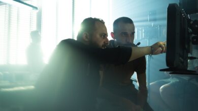 Film crew collaborating on set with cinematic lighting in Baghdad, Iraq, showcasing teamwork and creativity.
