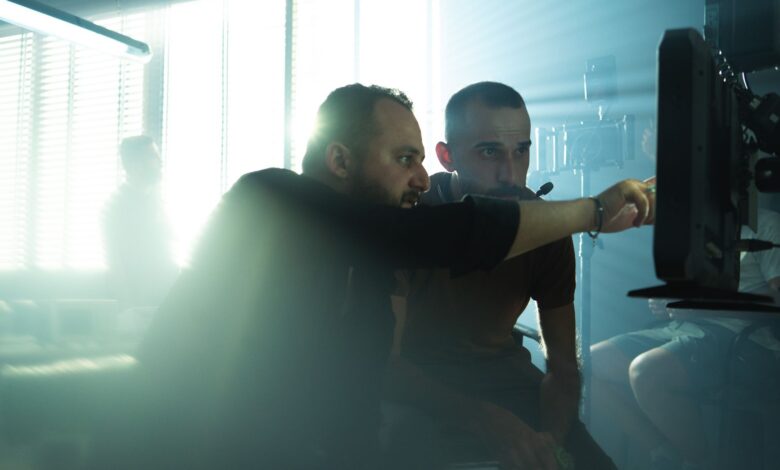 Film crew collaborating on set with cinematic lighting in Baghdad, Iraq, showcasing teamwork and creativity.