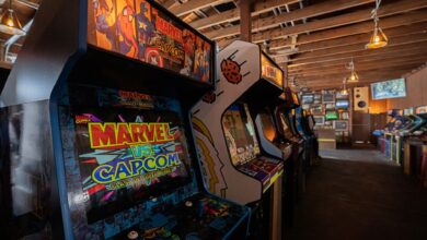 Modern arcade machines with bright luminous monitors and inscriptions in contemporary public entertainment center