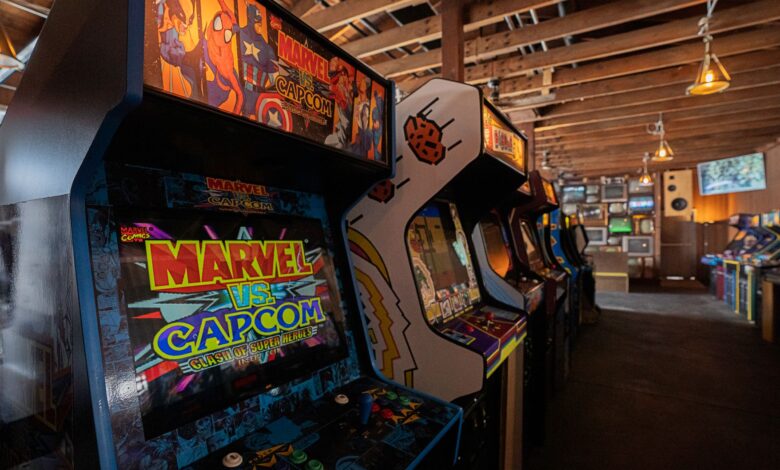 Modern arcade machines with bright luminous monitors and inscriptions in contemporary public entertainment center