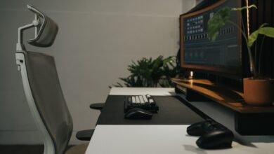Sleek modern workspace featuring an ergonomic chair and dual monitors, perfect for gaming and productivity.