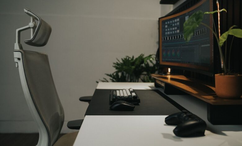 Sleek modern workspace featuring an ergonomic chair and dual monitors, perfect for gaming and productivity.