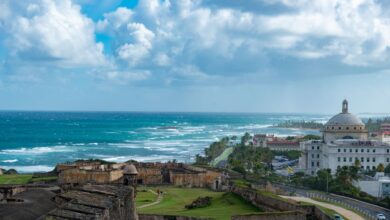 Captivating view of the historic San Juan coastline with El Morro fortress and ocean waves.