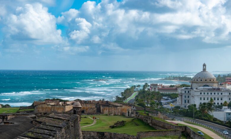 Captivating view of the historic San Juan coastline with El Morro fortress and ocean waves.
