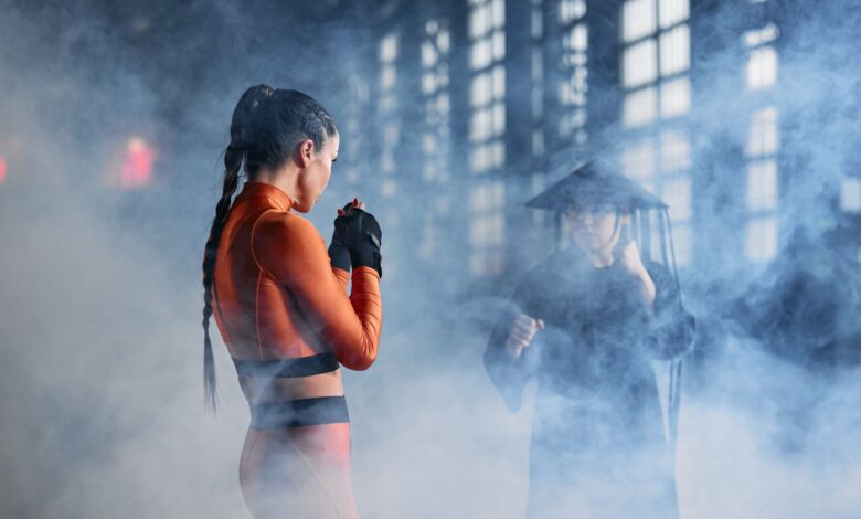 Two cosplayers in martial arts poses creating an intense and dramatic scene.