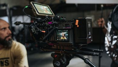 Close-up of a professional film camera setup with crew on a movie set, capturing behind-the-scenes action.