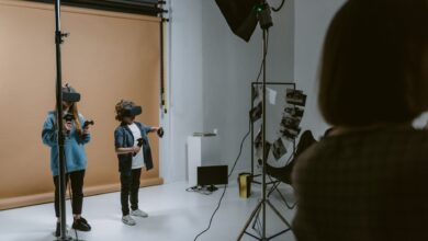 Two kids experience virtual reality gaming in a professional studio setting with VR headsets and controllers.