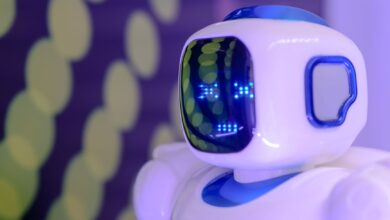 Close-up of a futuristic humanoid robot with a luminescent display in a modern setting.