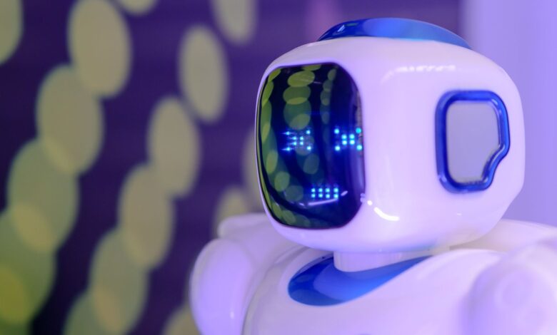 Close-up of a futuristic humanoid robot with a luminescent display in a modern setting.
