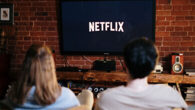 A couple relaxing and watching Netflix in a cozy living room setting.