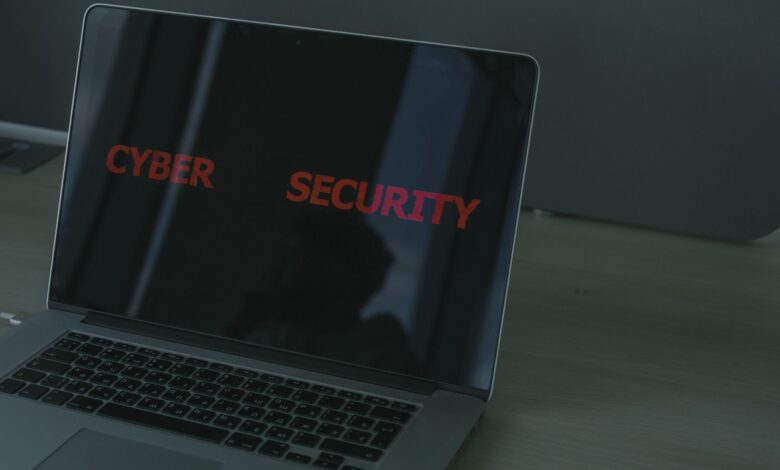 Close-up of a laptop displaying cybersecurity text, emphasizing digital security themes.
