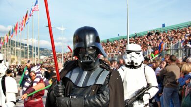 Colorful carnival parade in Menton, France featuring popular sci-fi cosplay characters attracting a large crowd.