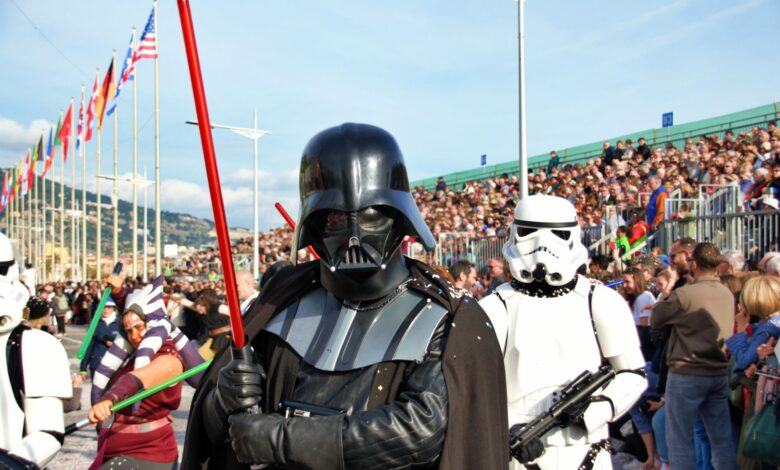 Colorful carnival parade in Menton, France featuring popular sci-fi cosplay characters attracting a large crowd.