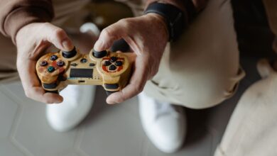 A person playing video games with a vintage-style controller indoors.