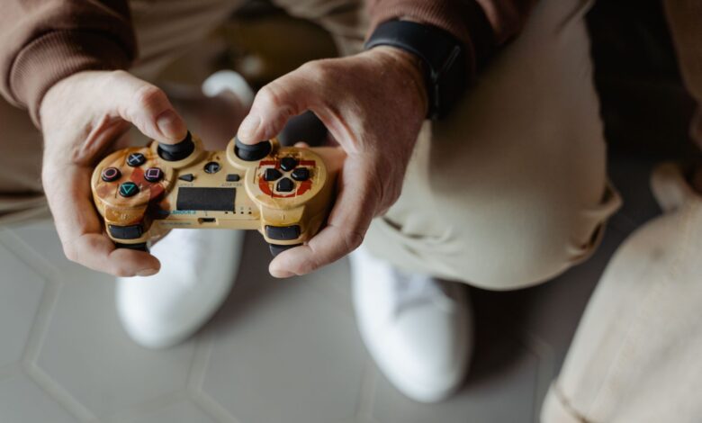 A person playing video games with a vintage-style controller indoors.