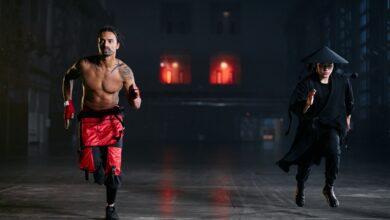 Two men in cosplay costumes running indoors, capturing a dramatic and intense scene.