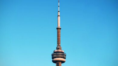 Close-up of Toronto's CN Tower reaching into a cloudless blue sky.