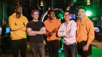 A diverse group of friends having fun and bonding at an arcade, showcasing friendship and joy.