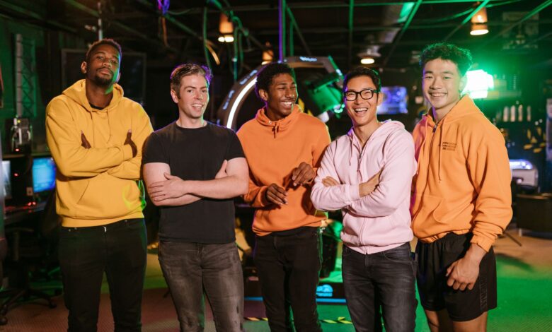 A diverse group of friends having fun and bonding at an arcade, showcasing friendship and joy.