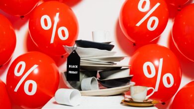 Red balloons with percentage signs surround dishes, highlighting Black Friday sales.