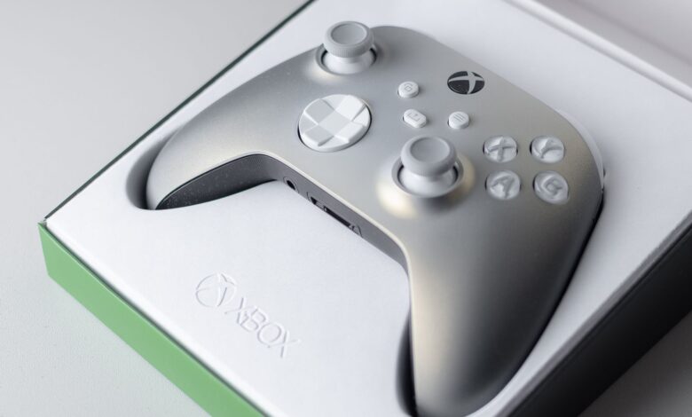 A high-quality close-up of an Xbox game controller in its packaging box, ready for gaming.