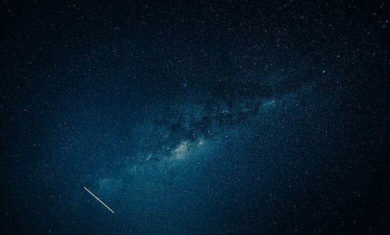 Captivating view of the Milky Way galaxy and a shooting star across a clear night sky.