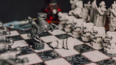 Close-up of a fantasy-themed medieval chess set with intricate details, highlighting a knight piece.
