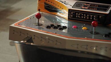 Close-up of a vintage arcade game control panel with joysticks and buttons.