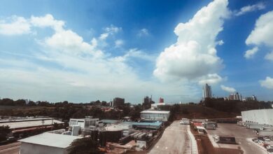 Aerial photograph showcasing a modern industrial area with buildings and clear skies, perfect for urban themed projects.