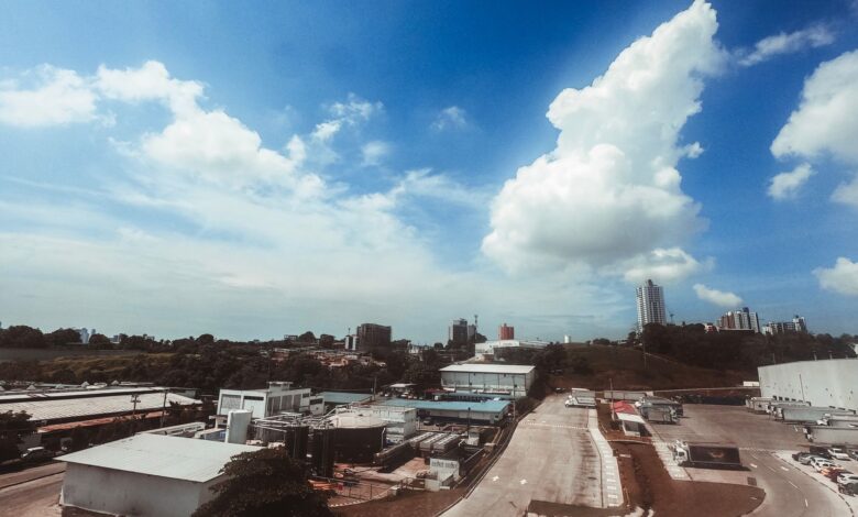 Aerial photograph showcasing a modern industrial area with buildings and clear skies, perfect for urban themed projects.