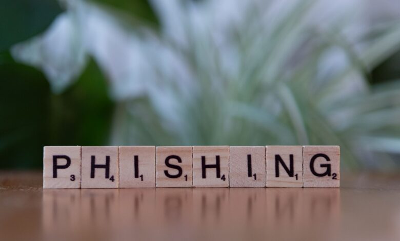 Wooden tiles spelling 'phishing' highlight cybersecurity themes.