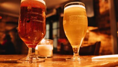 Warm and inviting pub setting with two beers on a wooden table.