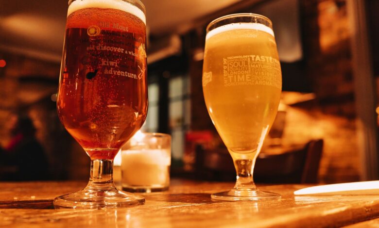 Warm and inviting pub setting with two beers on a wooden table.