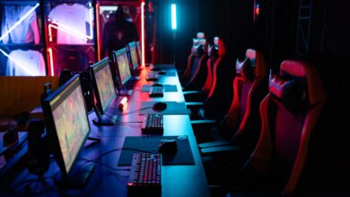 High-tech gaming setup with PCs, RGB lighting, and gaming chairs in a gaming house.