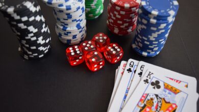 A vibrant display of casino chips, dice, and playing cards set on a table, embodying chance and excitement.