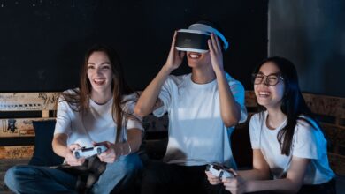 Group of friends having fun with VR gaming. Laughter, technology, and bonding moments indoors.