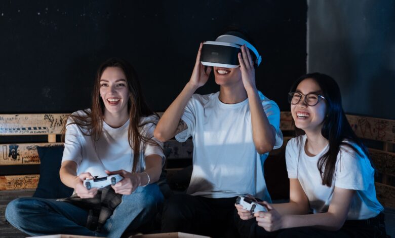 Group of friends having fun with VR gaming. Laughter, technology, and bonding moments indoors.