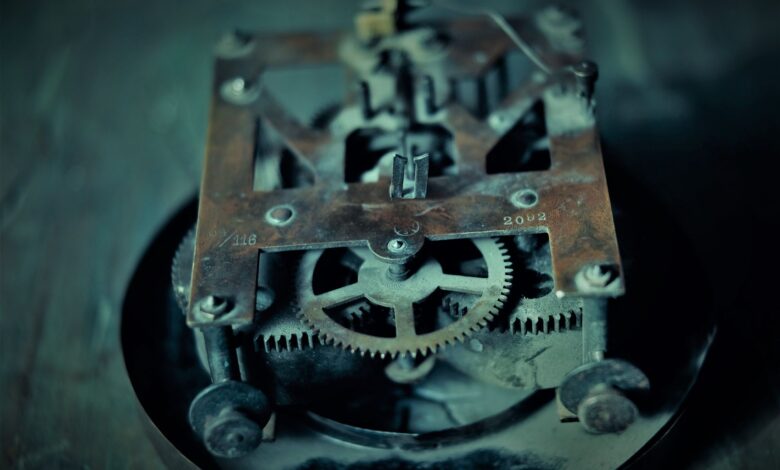 Close-up photo of an old rusty clock mechanism showcasing intricate gears and machinery.