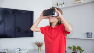 A child in a red shirt immerses in a virtual reality experience indoors.