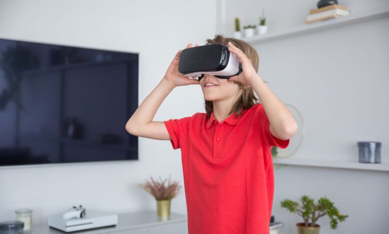 A child in a red shirt immerses in a virtual reality experience indoors.