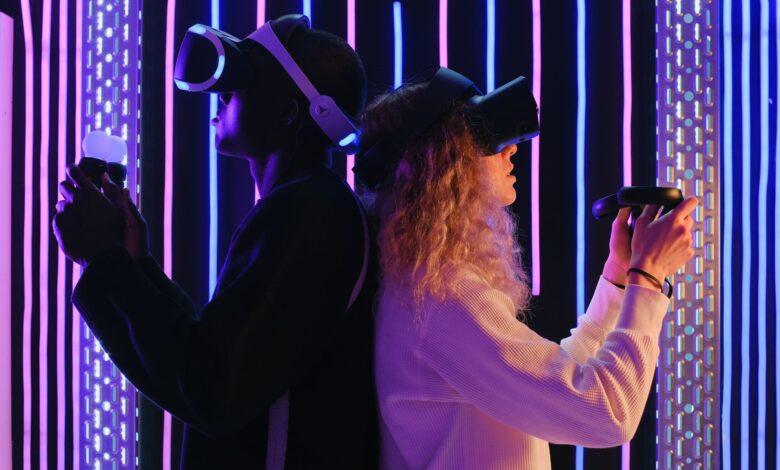 Two adults engaged in virtual reality gaming with VR headsets in a vibrant, neon-lit environment.