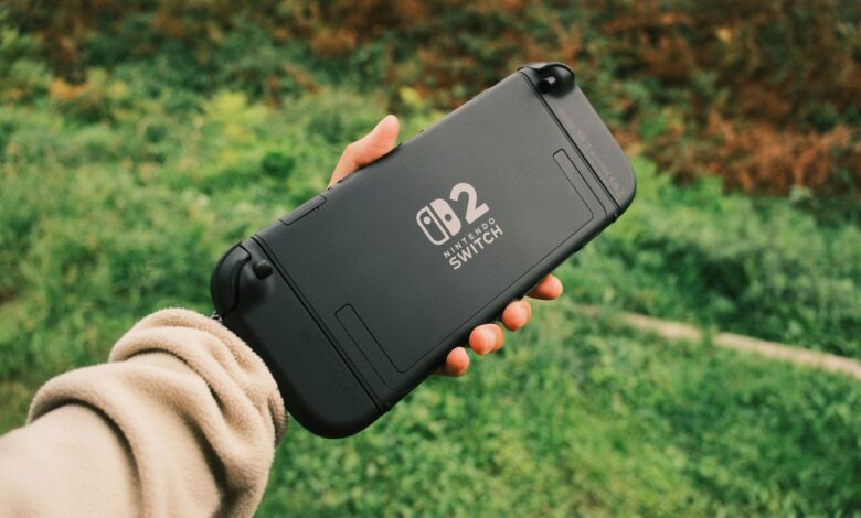 Person holding a Nintendo Switch in a natural outdoor setting, perfect for on-the-go gaming.