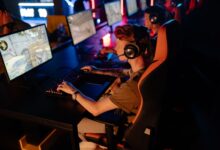A group of gamers focused on a competitive match in a dimly lit esports arena.