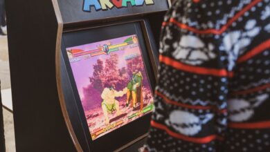 A person in a sweater enjoying a classic arcade game in Zagreb, Hrvatska.