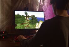 A young man intensely playing a PC video game indoors. Capturing the essence of technology and concentration.