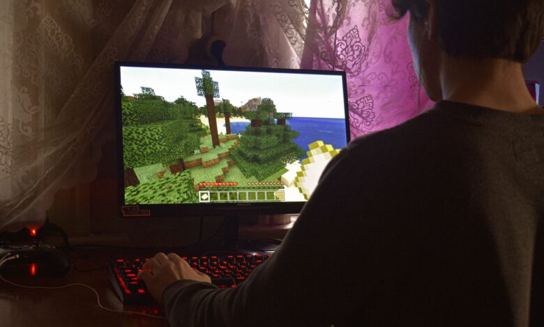 A young man intensely playing a PC video game indoors. Capturing the essence of technology and concentration.