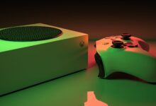 Close-up of an Xbox Series console and controller with dynamic lighting, showcasing modern gaming technology.